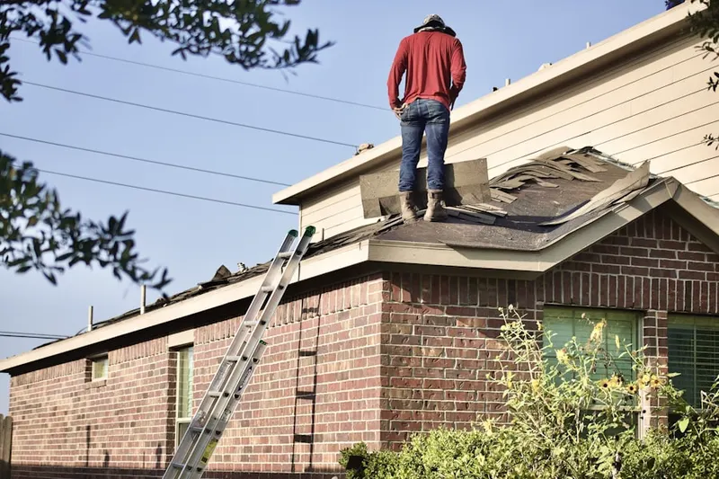 Professional roofer working on a residential roof in Little Ethiopia